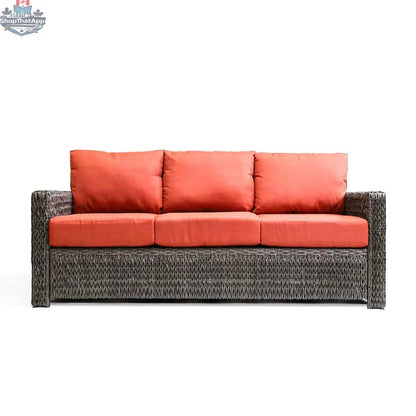 Krikacy Laguna Point outdoor wicker sofa with brown frame and orange cushions, stylish patio seating for relaxing outdoors.