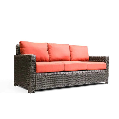 Krikacy Laguna Point outdoor wicker sofa with brown frame and orange cushions for stylish patio seating.