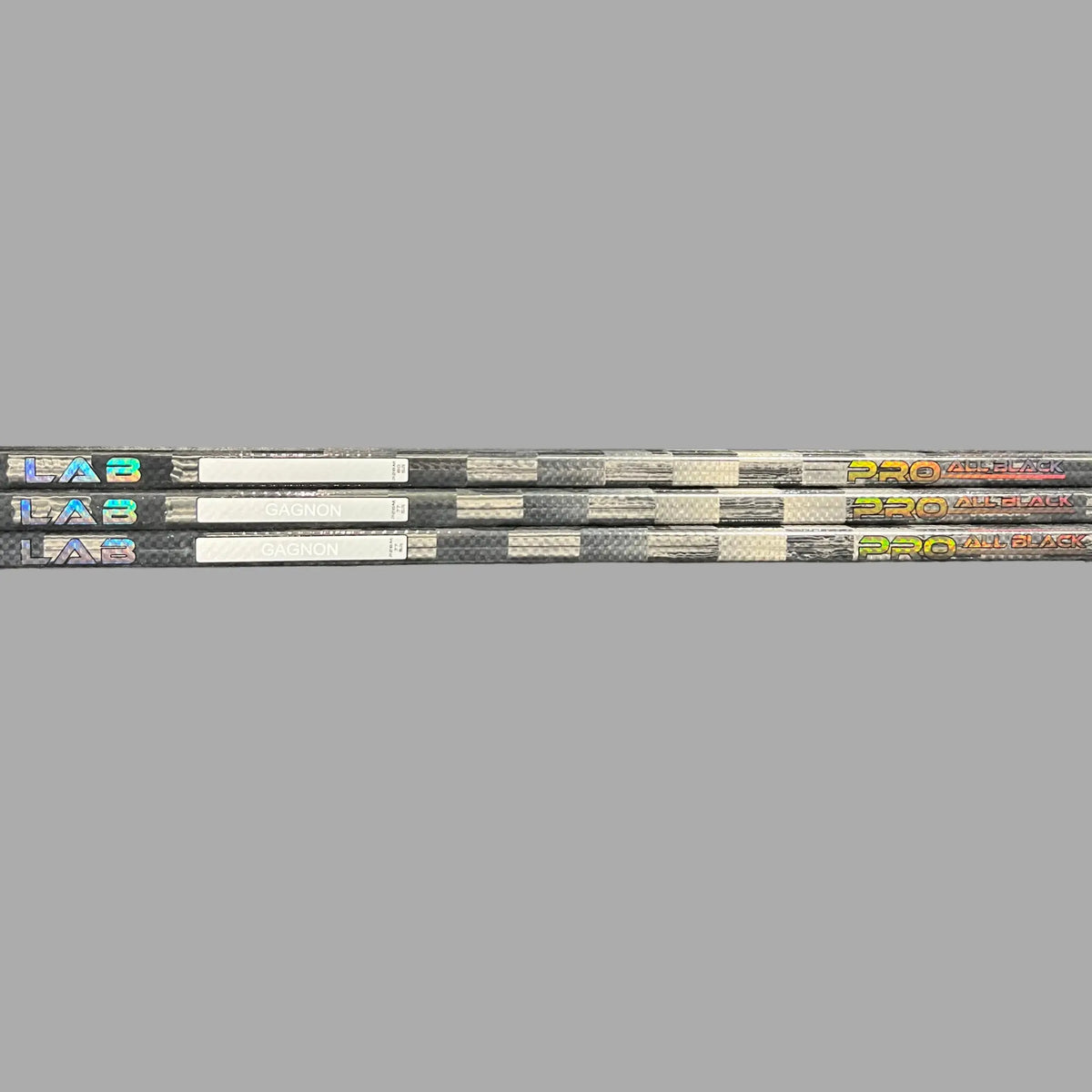 LabSports Pro All Black V2 hockey stick featuring a carbon shaft for intermediate performance and sleek black design.