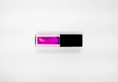 FencyGrace vegan fruit repulpant lip oil in a clear tube with a gold cap, showcasing glossy, nourishing lip care.