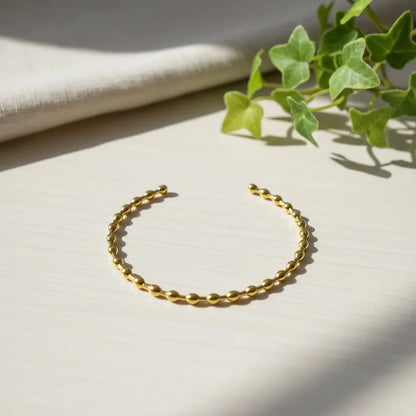 Suzie Blue Canada gold plated bracelet bangle worn as a stylish accessory in a lifestyle setting.