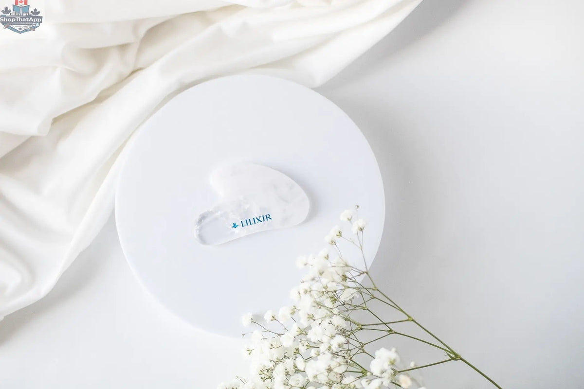 LILIXIR gift set for night routine including white crystal Gua Sha tool and skincare products, arranged neatly on a white surface.