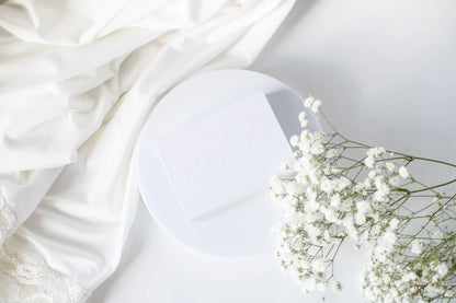 White crystal Gua Sha tool for facial massage and acupressure by LILIXIR, showcasing smooth, polished stone for skincare.