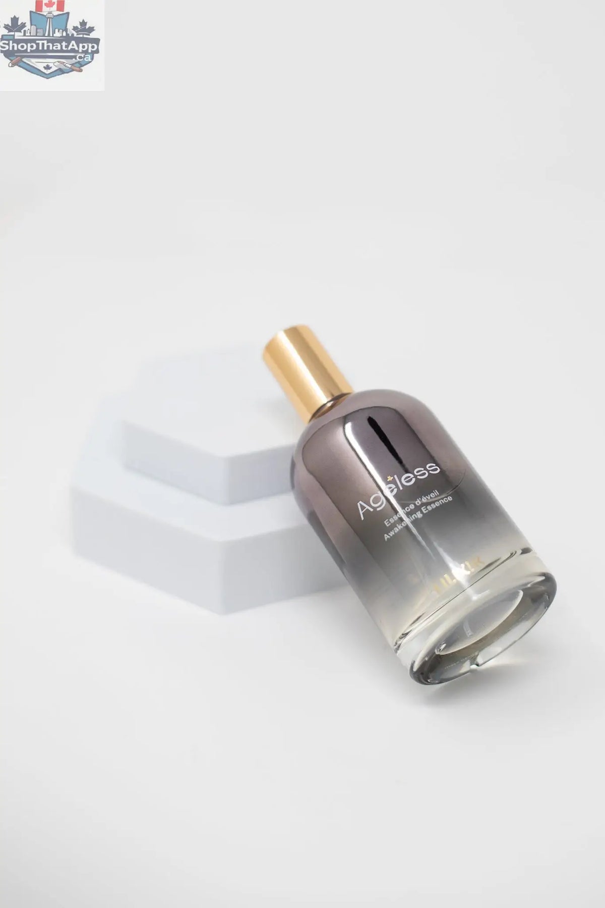 LILIXIR Ageless Awakening Essence mist in a clear spray bottle, botanical ingredients visible, designed for skin revitalization and hydration.
