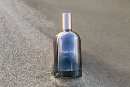 LILIXIR Ageless Awakening Essence mist in a clear spray bottle with a minimalist label, designed for skincare and rejuvenation.