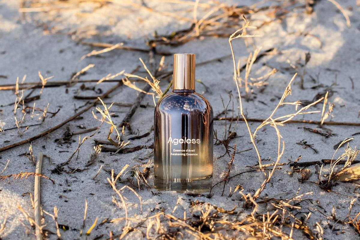 LILIXIR Ageless Awakening Essence mist in a clear spray bottle with a minimalist design, ready for skincare application.