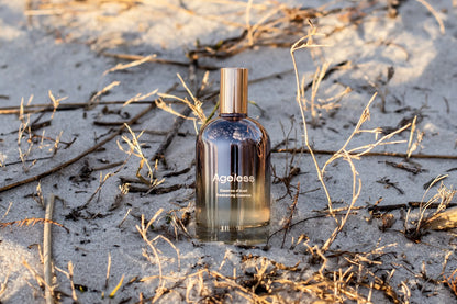 LILIXIR Ageless Awakening Essence mist in a clear spray bottle with a minimalist design, ready for skincare application.