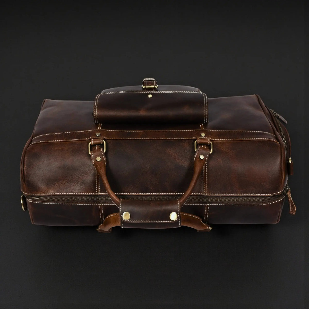Brown leather duffle bag in full-grain distressed leather with sturdy handles, from NAB Leather's Voyager Duffle collection.