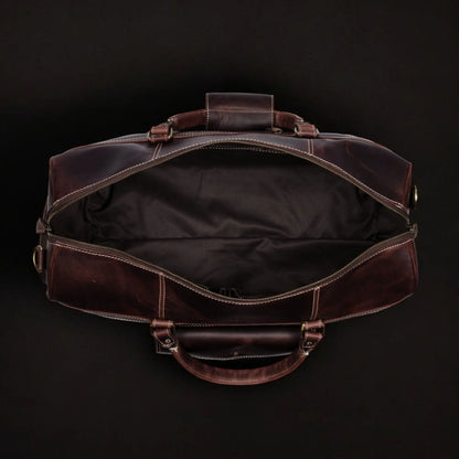 Brown full-grain distressed leather Voyager Duffle bag by NAB Leather, showing sturdy handles and spacious design.