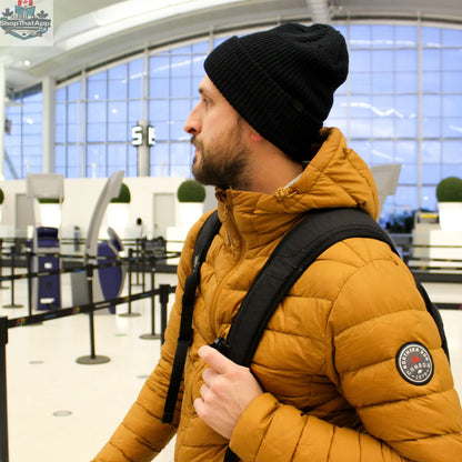 Lightweight Northern Sun men's packable down jacket, shown folded and packed for travel, with a sleek, insulated design.