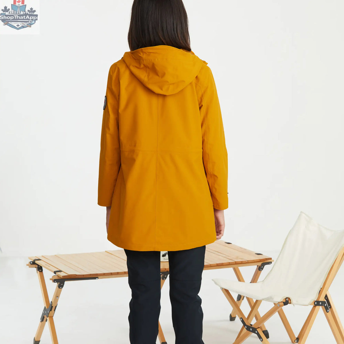 Yellow women's 3-in-1 waterproof winter jacket by Northern Sun, mid-length design, styled for outdoor winter activities.