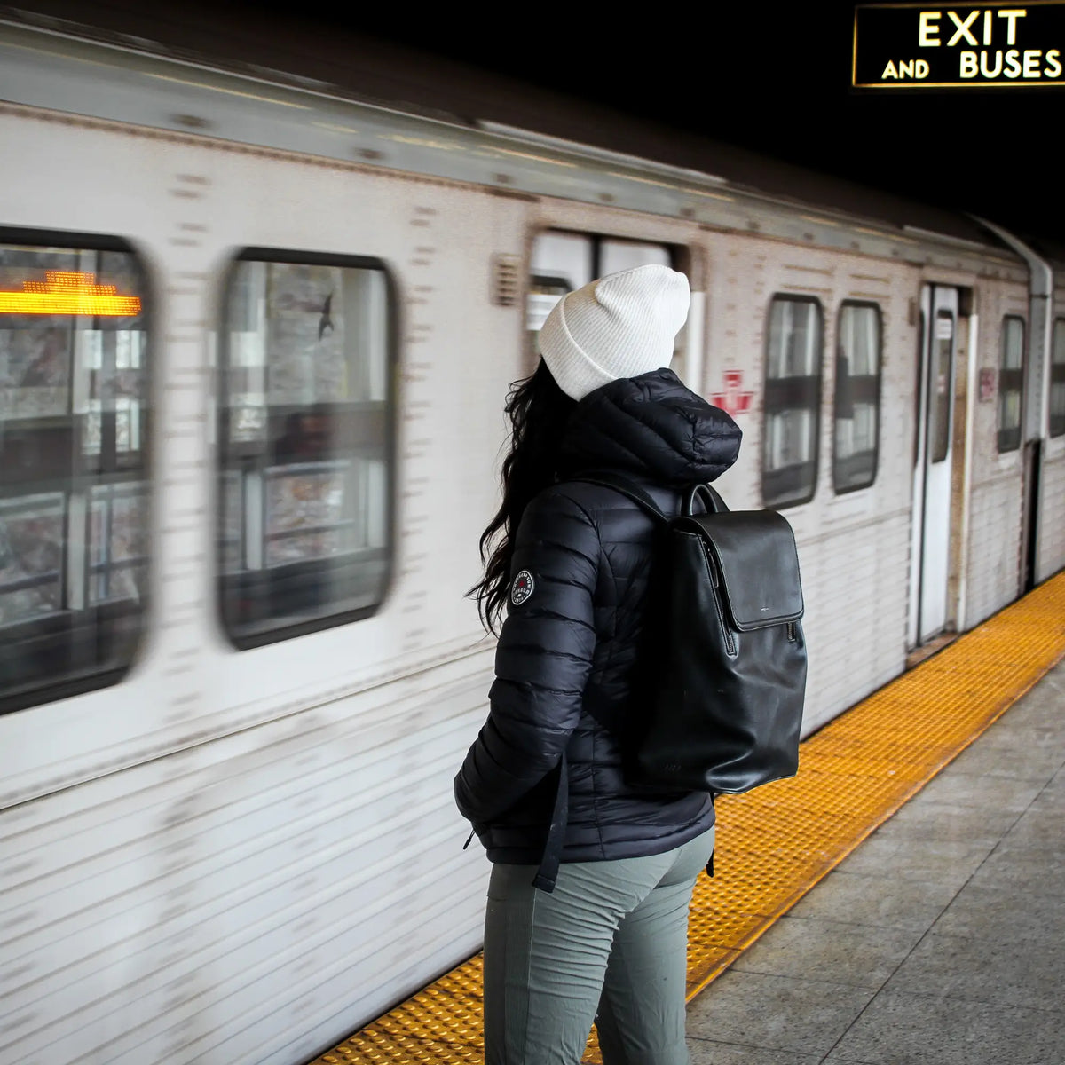 Northern Sun women's packable down jacket, lightweight and suitable for commuting, shown in a city setting.