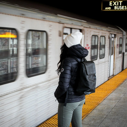 Northern Sun women's packable down jacket, lightweight and suitable for commuting, shown in a city setting.