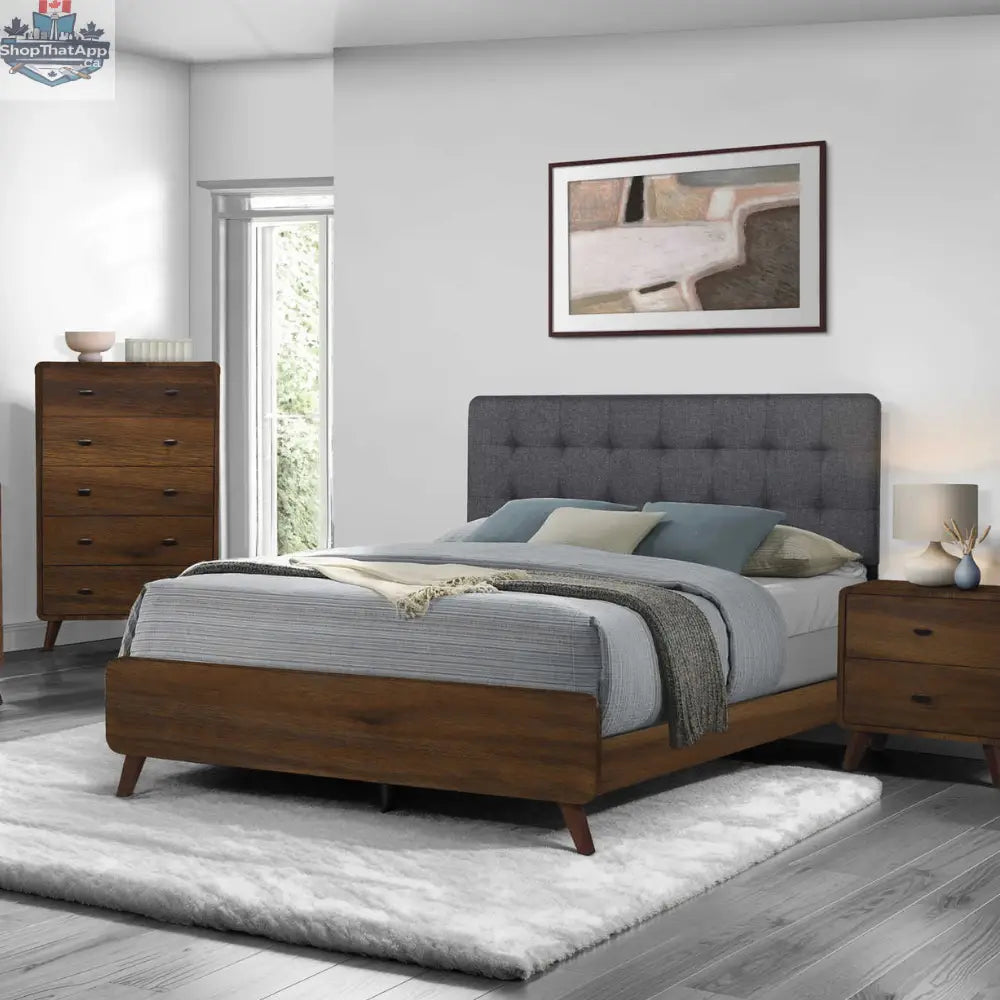 Queen bed base in walnut wood and gray fabric from Monarch, featuring a modern bedroom furniture design.