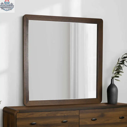 Elegant wall mirror with walnut finish from Monarch, ideal for bedroom decor, showcasing a sleek, modern design.