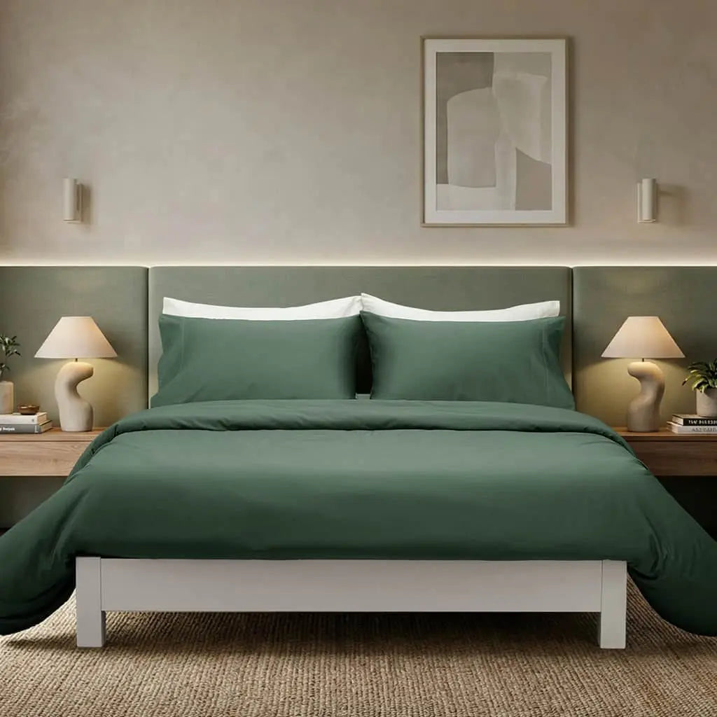 Soft, silky Skylark+Owl Canada refined sateen sheet set with neatly folded sheets and pillowcases on a bed for luxurious bedroom comfort.