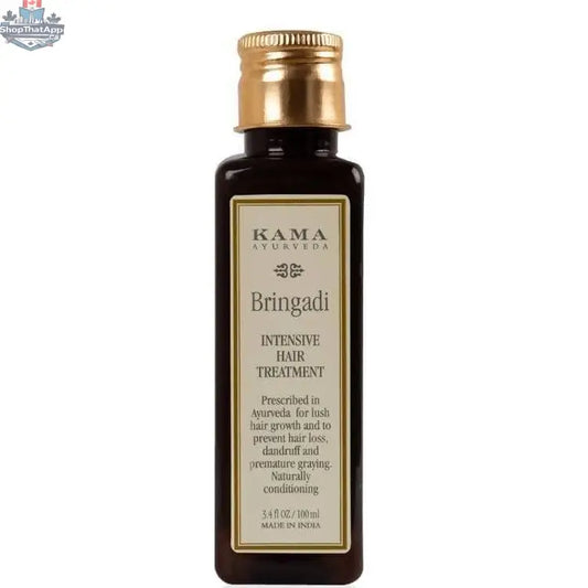 Kama Ayurveda Bringadi Hair Oil for intensive hair treatment, featuring a dark glass bottle with a dropper, surrounded by herbs.