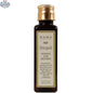 Kama Ayurveda Bringadi Hair Oil for intensive hair treatment, featuring a dark glass bottle with a dropper, surrounded by herbs.