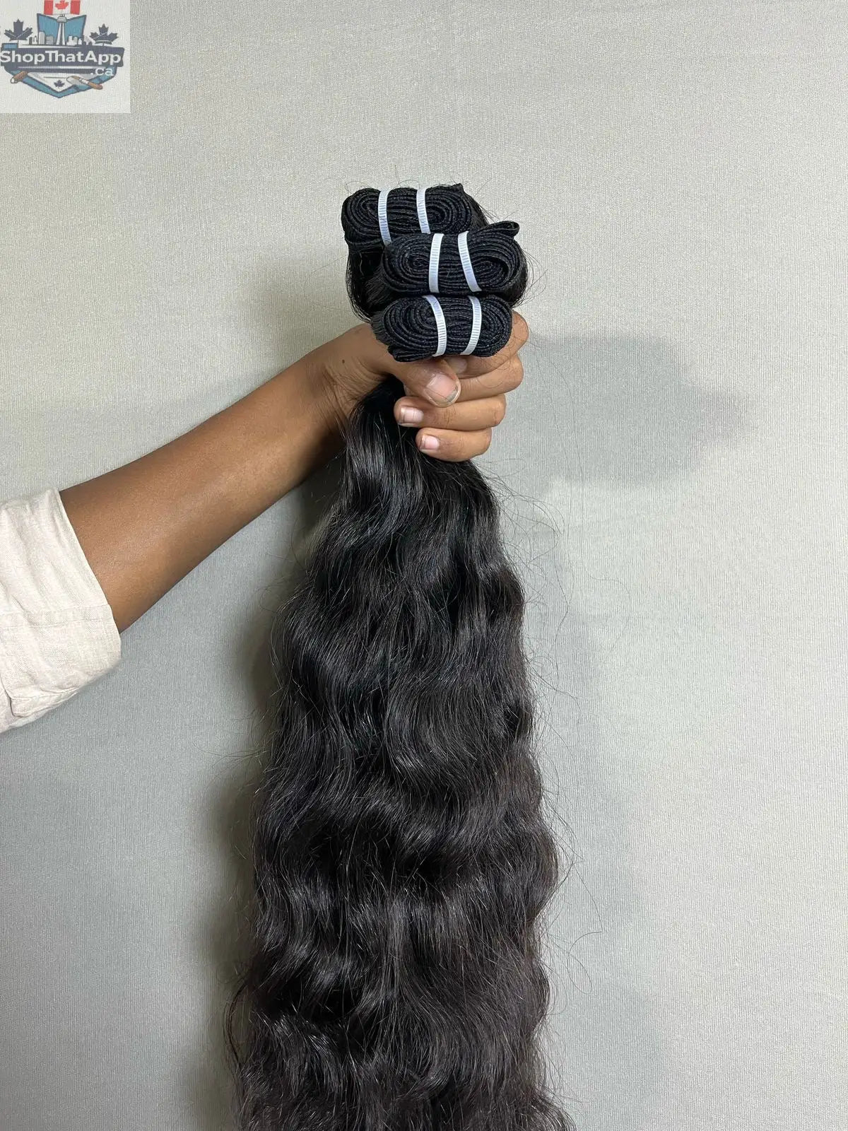 Three bundles of premium Indian curly human hair extensions from Prithvi Mart, showcasing rich, natural curly texture and quality.