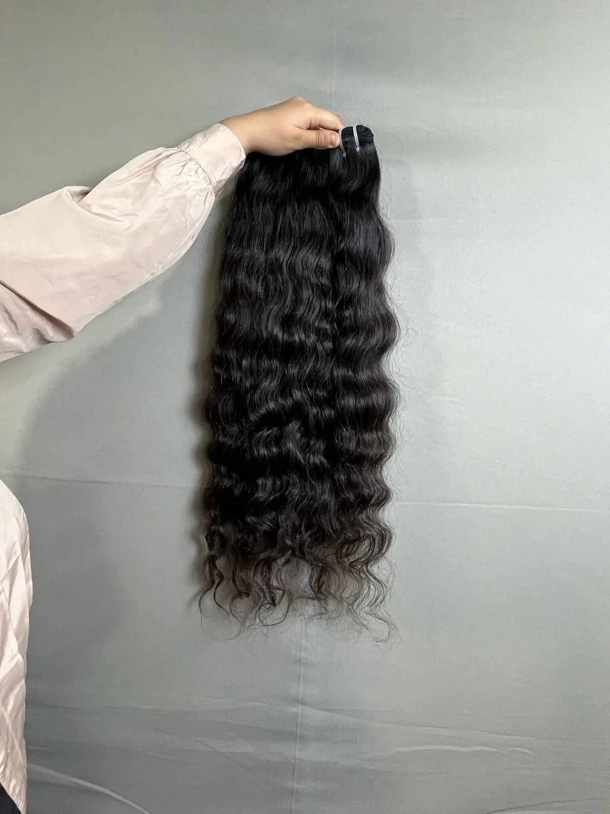 Indian curly human hair extensions bundle from Prithvi Mart, showcasing thick, curly hair with natural shine and texture.