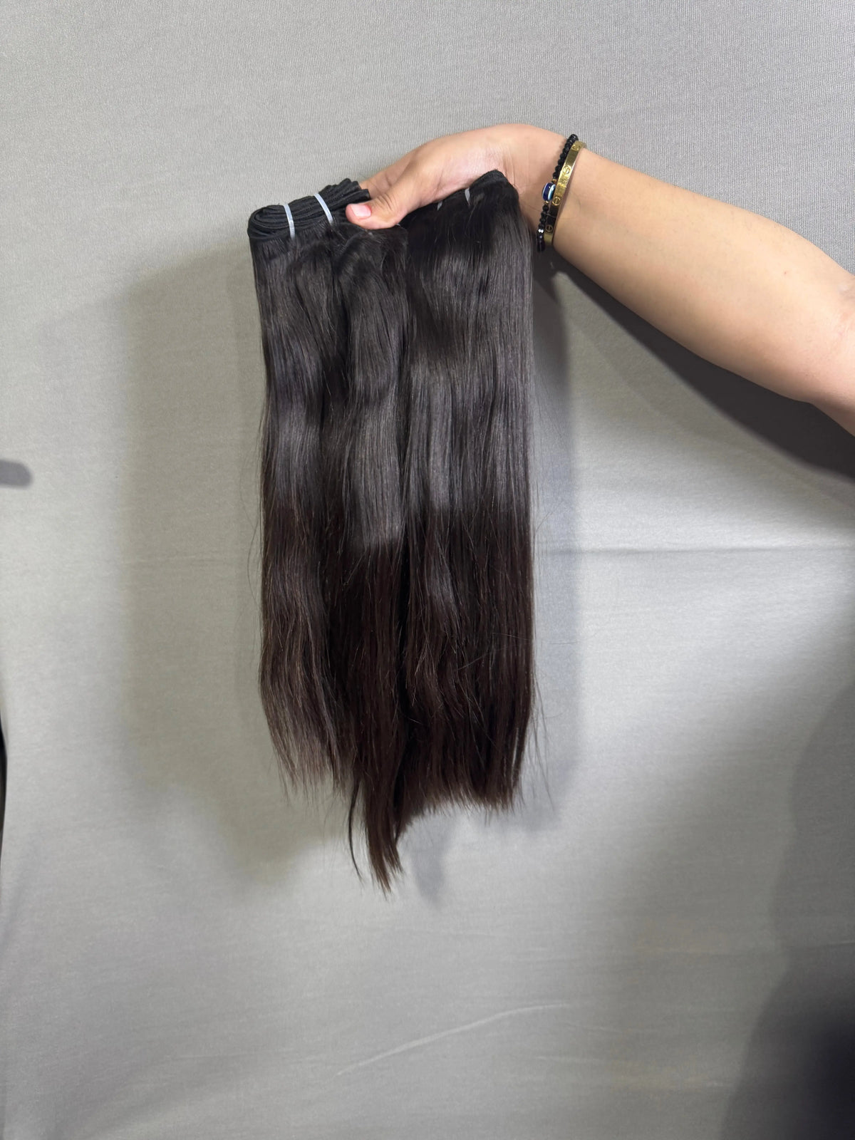 Indian straight hair bundles from Prithvi Mart, showcasing natural, raw hair extensions with smooth, straight texture.