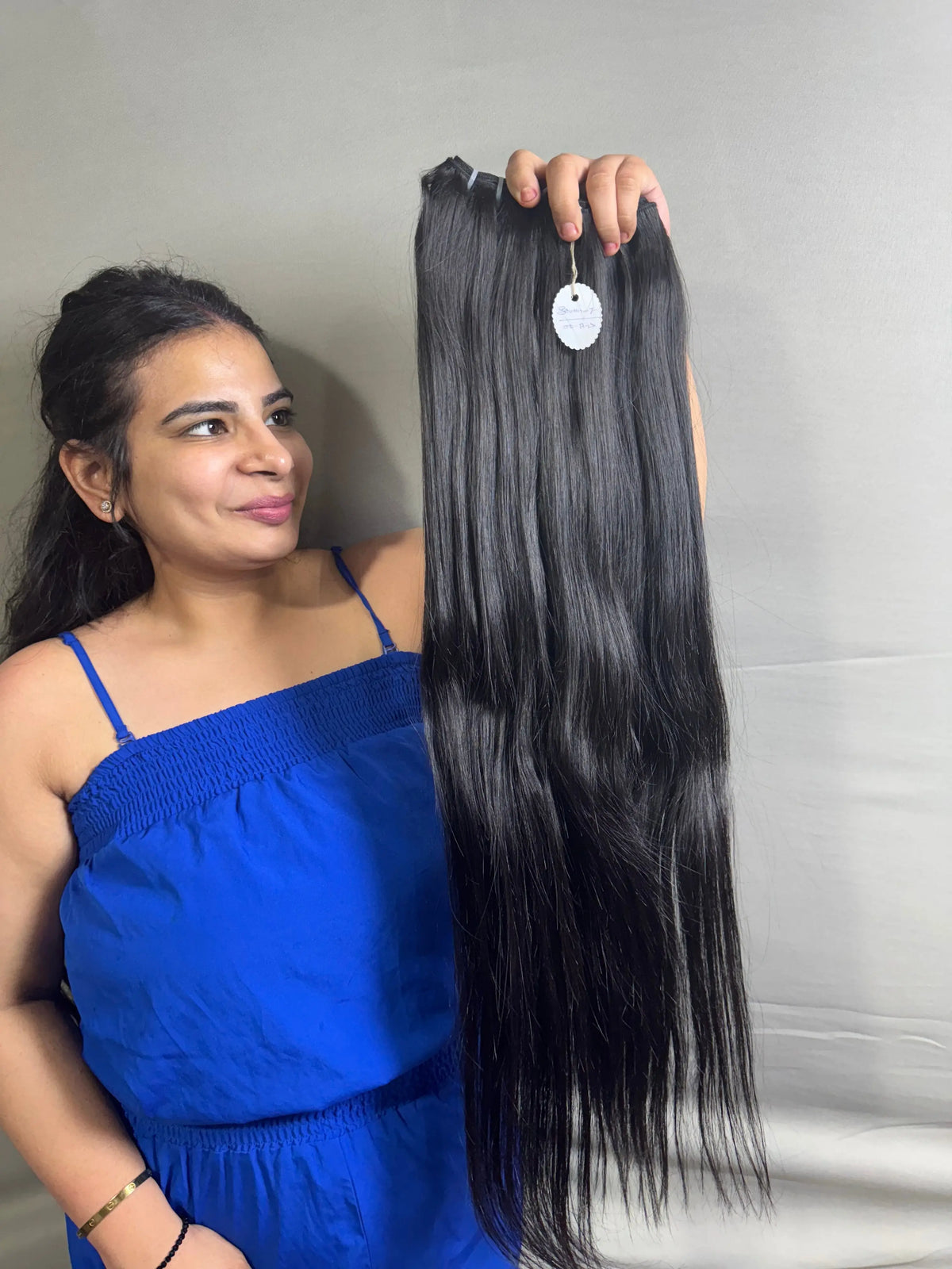 Indian straight hair bundles from Prithvi Mart, showing 100% raw natural quality hair extensions in a bundle arrangement.