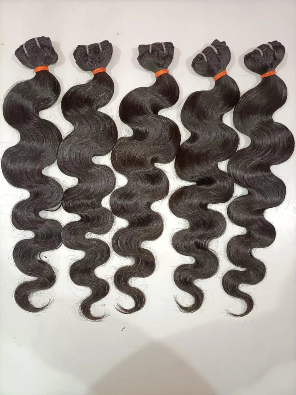 Indian Virgin Body Wave Hair Bundles from Prithvi Mart, showcasing smooth, wavy hair extensions for wholesale and retail use.