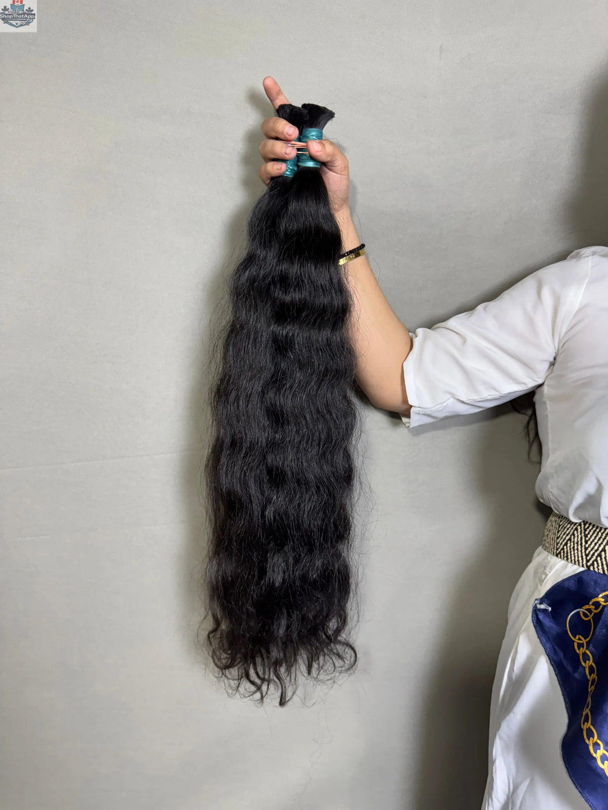 Raw Indian Wavy Hair bundles from Prithvi Mart, showing thick, natural-looking wavy hair extensions in a bundle style.