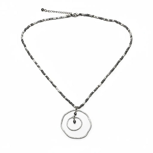 Silver plated Beaten Double Ring Necklace by Suzie Blue Canada featuring an elegant, unique jewelry design with intertwined rings.