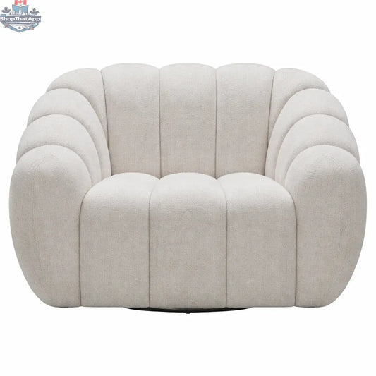 Cream Riro swivel accent chair by Hygge Design House with plush channeled upholstery and a modern, rounded design.