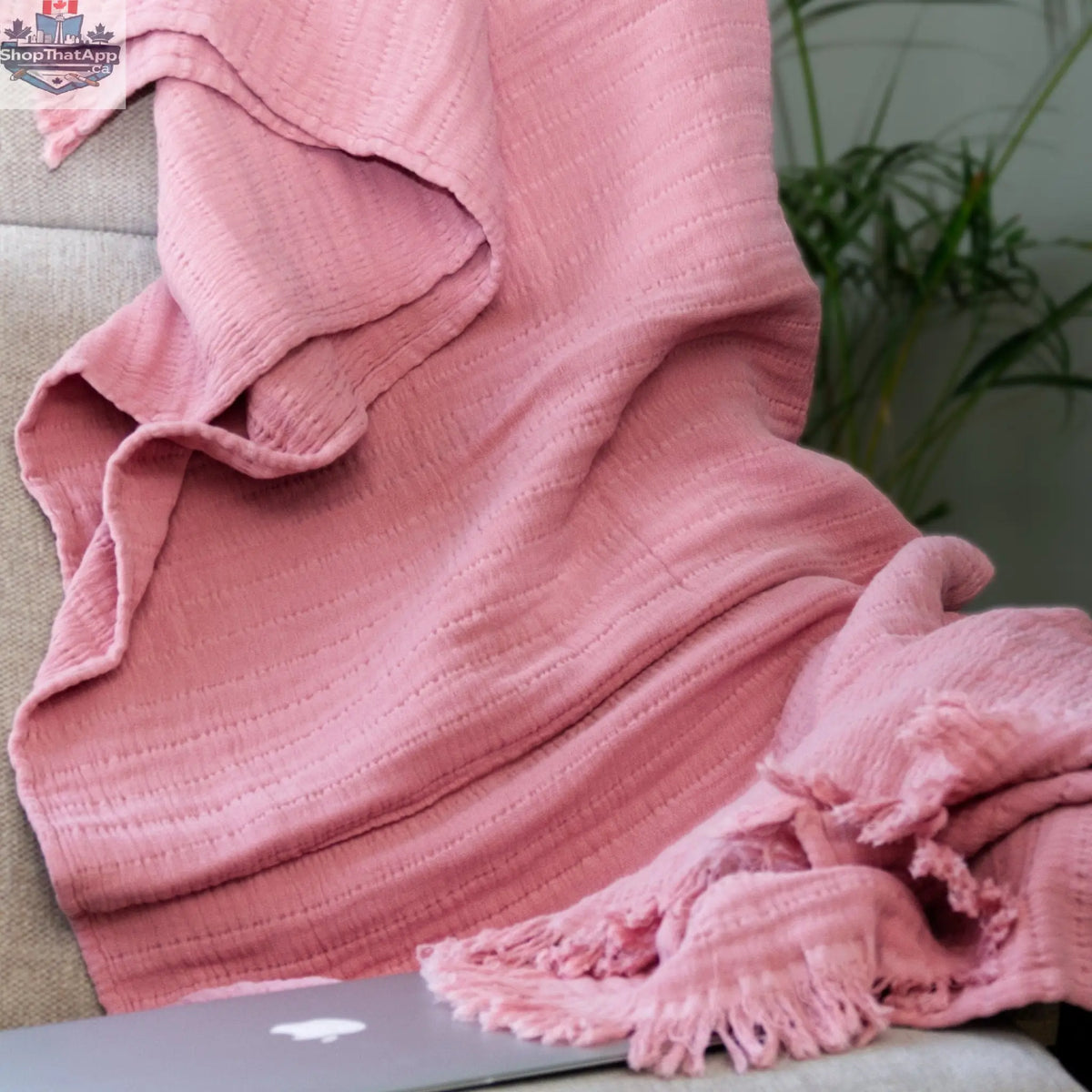 Pink wearable seersucker cotton throw by Hem and Tassel, designed for cozy comfort and versatile wear.