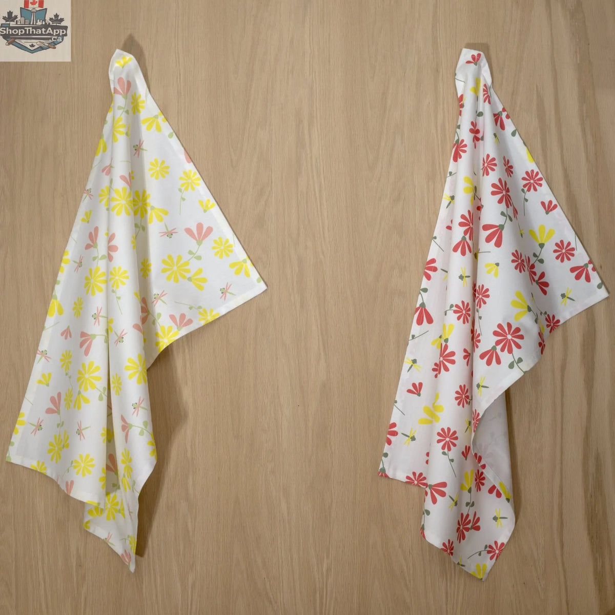 Two printed Shy Dragonfly Tea Towels with yellow accents hanging, made by Hem And Tassel for kitchen decor.