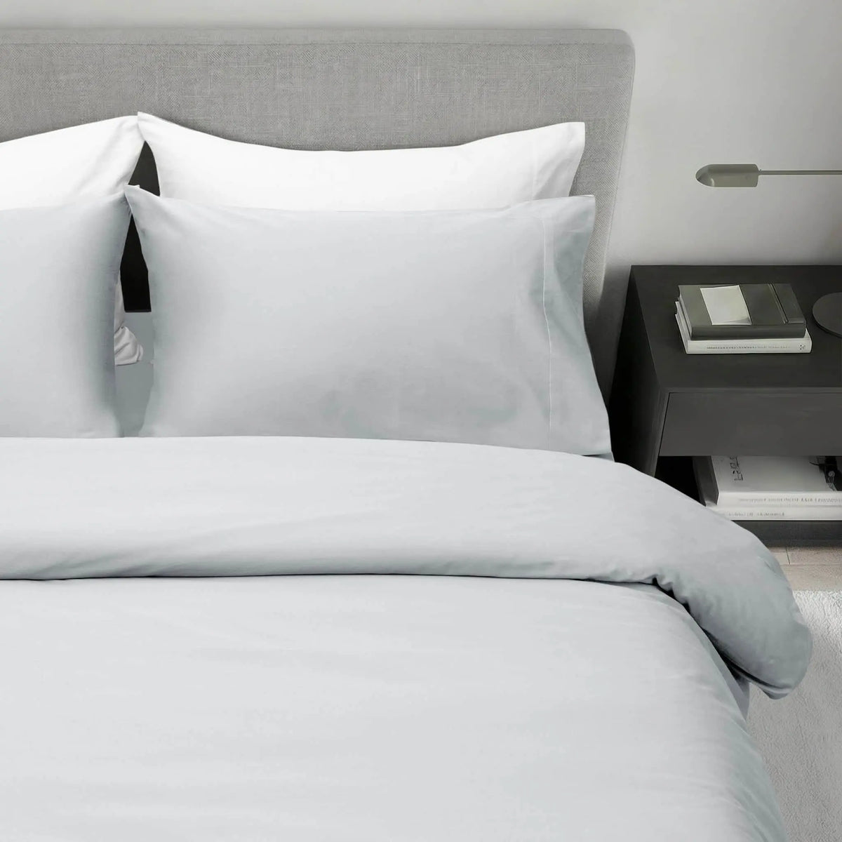 Light grey refined sateen fitted sheet by Skylark+Owl Canada, showcasing smooth, luxurious bedding fabric on a neatly made bed.