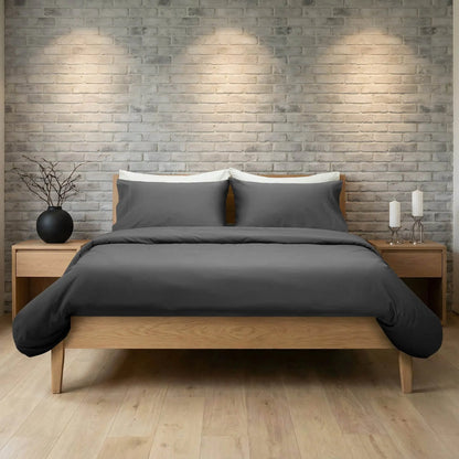 Slate-colored Skylark+Owl Canada refined sateen fitted sheet on a bed, showcasing smooth, luxurious fabric and perfect fit.