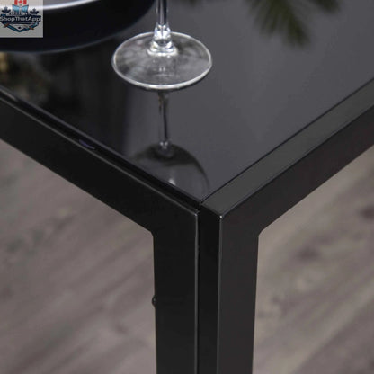 Black Zaya glass dining set by SLOTH Nation with 5 rectangular table and chairs, ideal for small spaces.