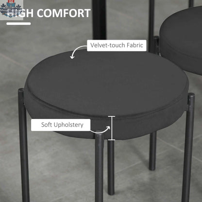 Set of four black Noel backless round dining stools with metal legs by SLOTH Nation, perfect for modern kitchen or dining area.