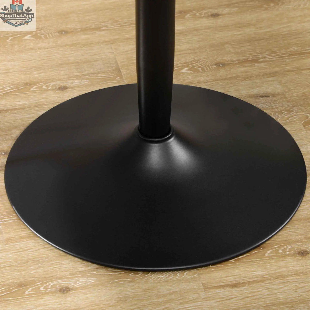 Modern black round dining table by SLOTH Nation with steel base, ideal for small spaces in home kitchen or dining areas.