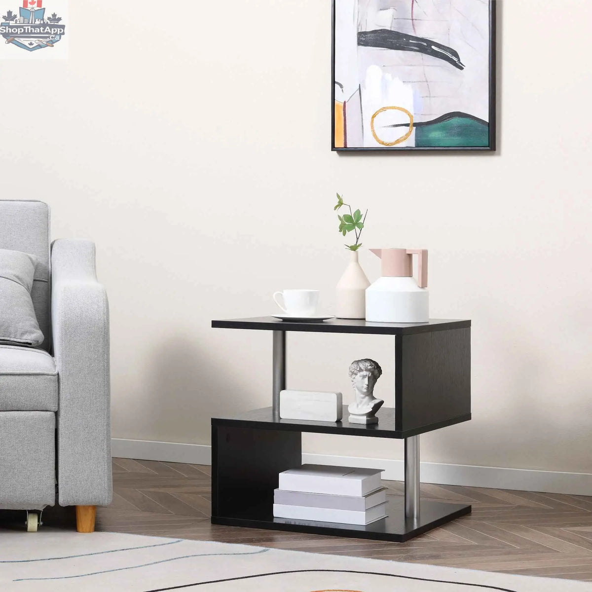 Caelan wooden S-shape end table with three-tier black storage shelves, perfect for living room organization and style.