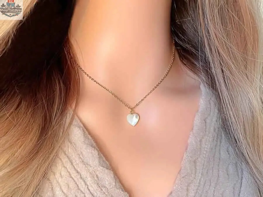 24K gold seashell heart necklace by SLOTH Nation featuring a delicate seashell pendant on a fine chain.