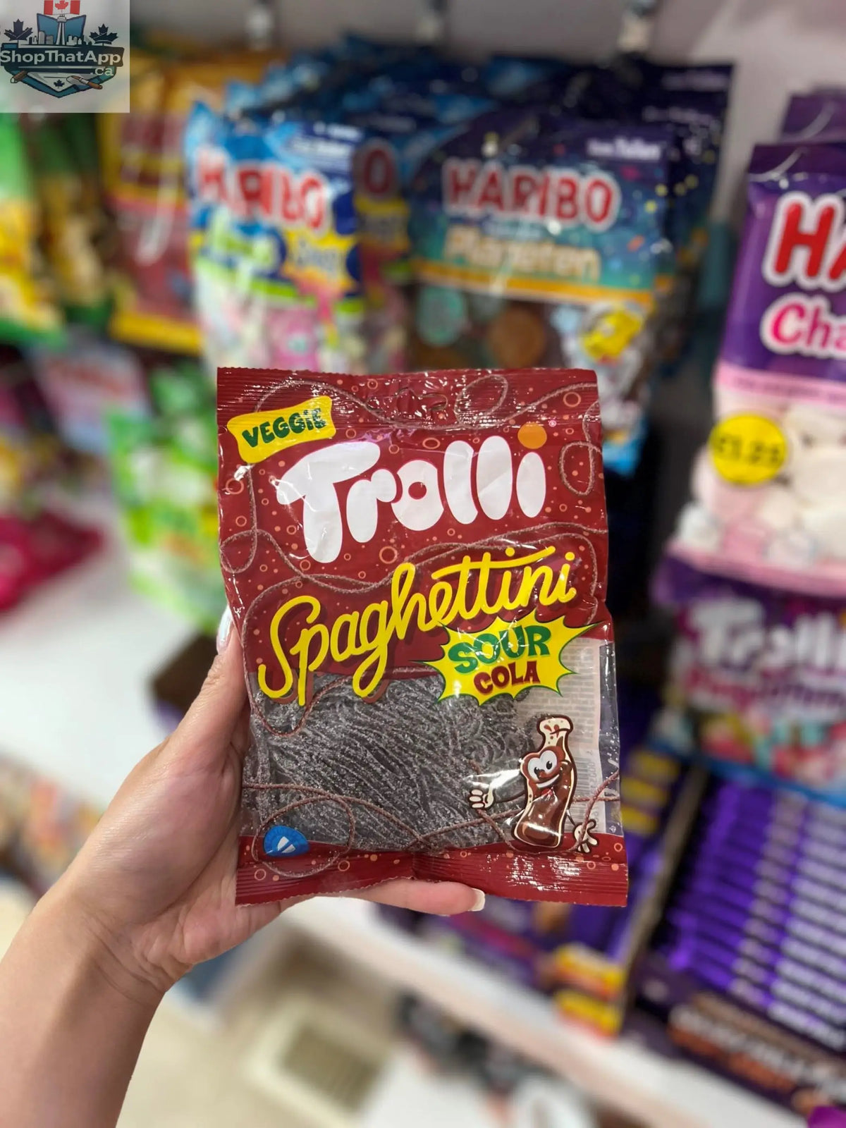 Germany Trolli Spaghettini Sour Cola candy packet from Snack Bar Co, showing colorful sour cola flavored gummy spaghetti.