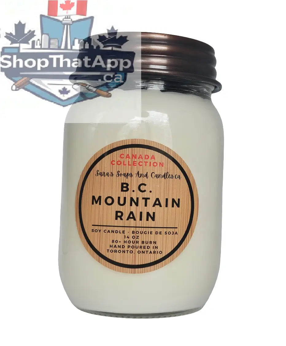 BC Mountain Rain soy candle by Stopandsmellthecandles, 14oz, with a mountain and rain scene on the label, ideal for aromatherapy.
