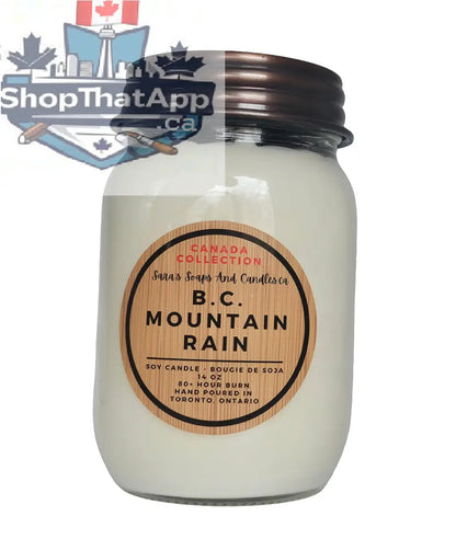 BC Mountain Rain soy candle by Stopandsmellthecandles, 14oz, with a mountain and rain scene on the label, ideal for aromatherapy.