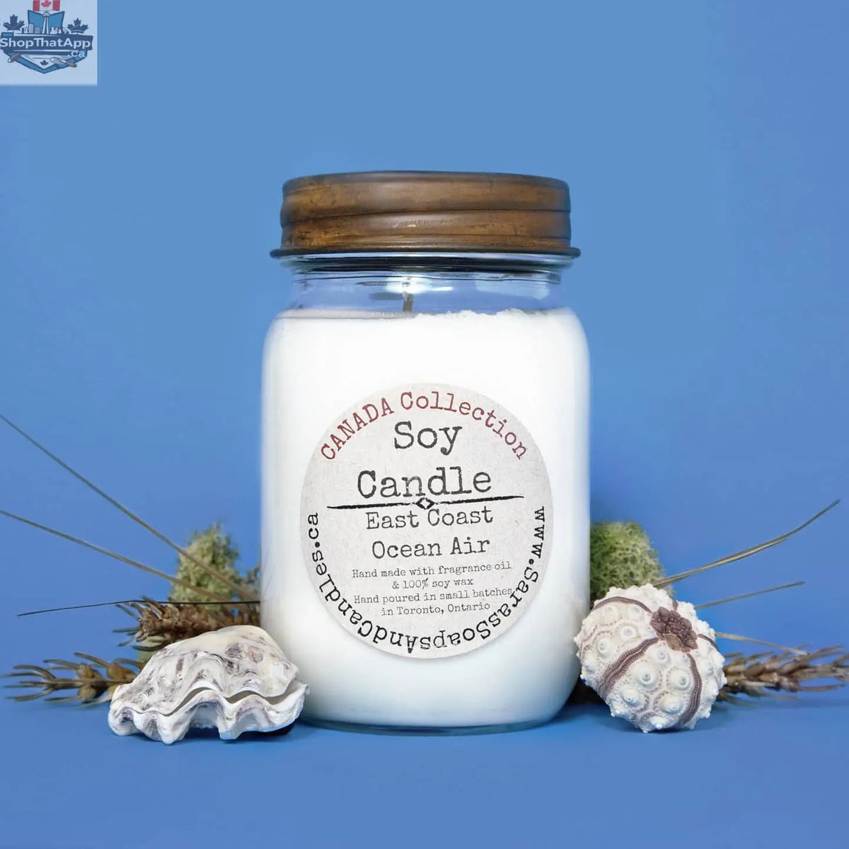 14oz East Coast Ocean Air soy candle by Stopandsmellthecandles, showing a large jar with a coastal-inspired label and a lit wick.