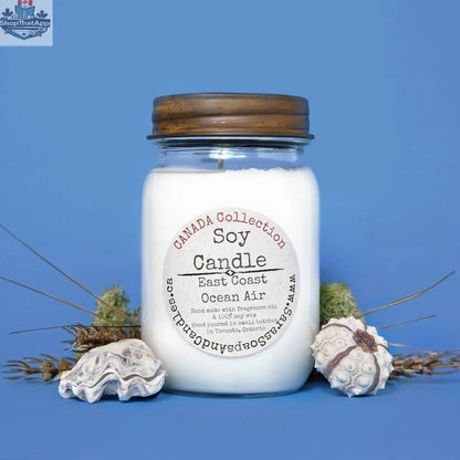 14oz East Coast Ocean Air soy candle by Stopandsmellthecandles, showing a large jar with a coastal-inspired label and a lit wick.