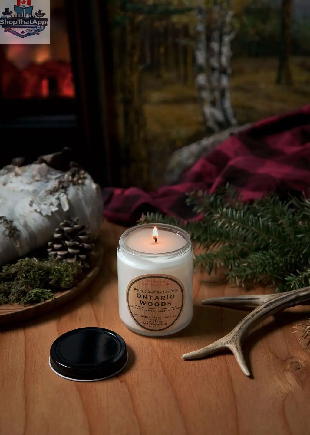 8 oz Ontario Woods soy candle by Stopandsmellthecandles with a cotton wick, featuring a rustic wooden label and warm candle glow.