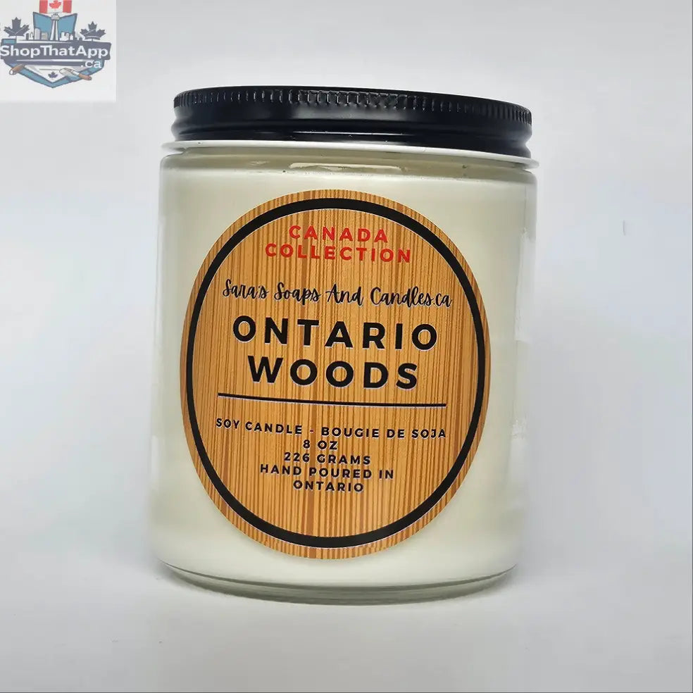 Stopandsmellthecandles Ontario Woods soy candle in an 8 oz glass jar with a wooden lid, showcasing a cozy, natural wood scent.
