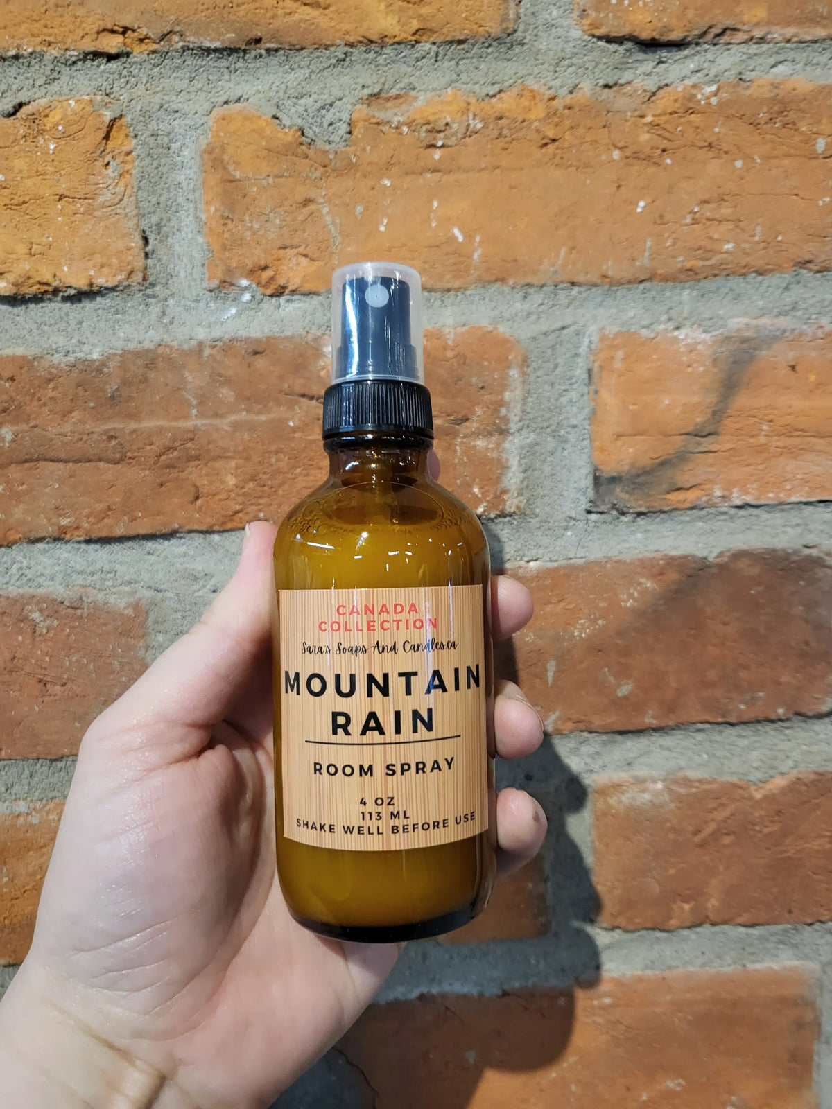Stopandsmellthecandles room spray bottle with a floral label, designed for freshening indoor spaces.