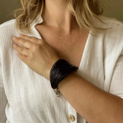 Colorful multi-strand thread bracelet by Suzie Blue Canada featuring vibrant, intertwined threads on a simple adjustable band.