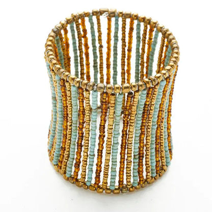 Beaded column cuff bracelet by Suzie Blue Canada featuring intricate beaded design and metallic accents.