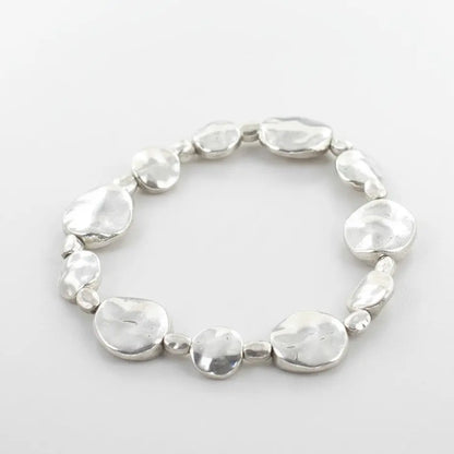 Silver plate beaten disc bracelet by Suzie Blue Canada, featuring a textured, elegant design for versatile occasions.